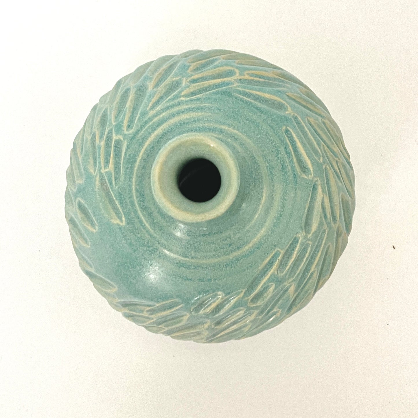 Long neck carved vase in soft blue