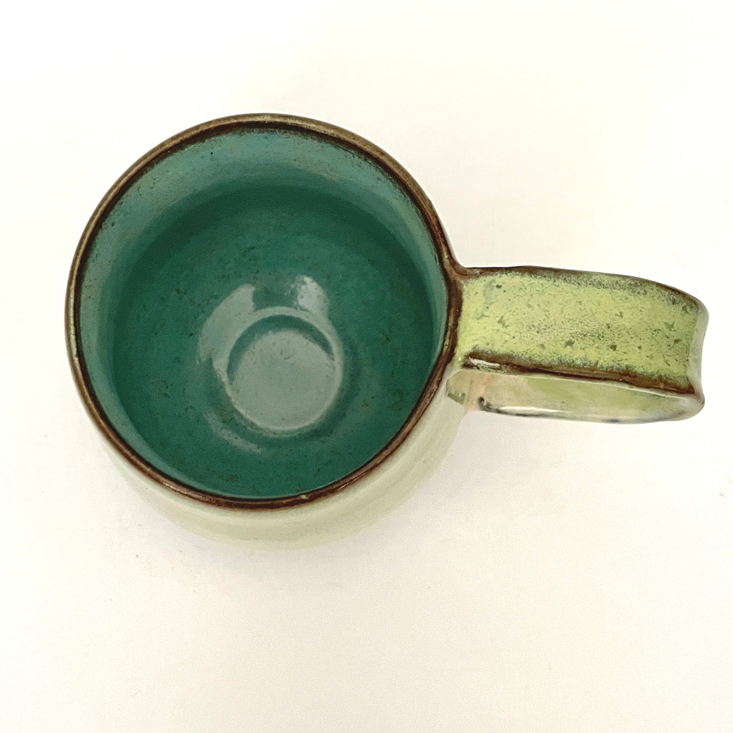 Green with Turquoise Interior Mug on Dark Clay