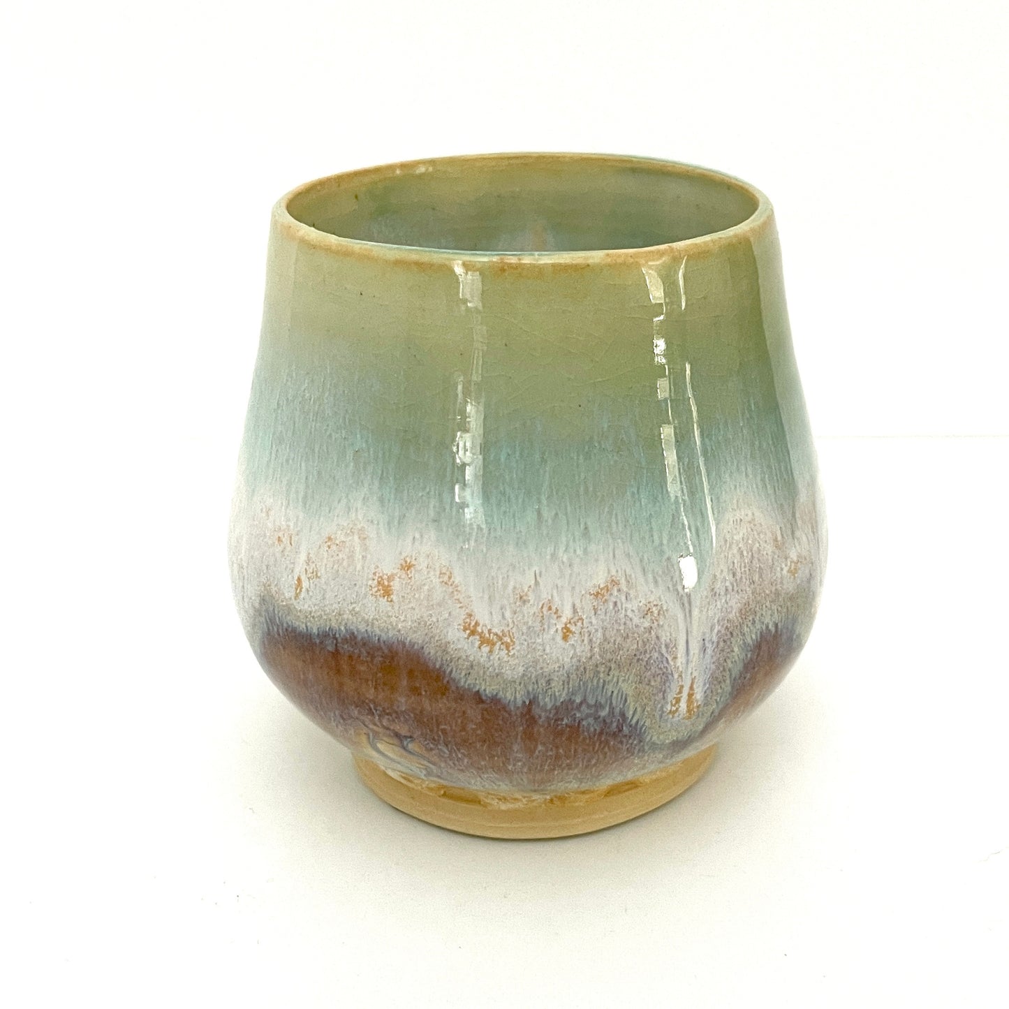 Small Delicate tea or drink cups in tones of white, seafoam and rust.