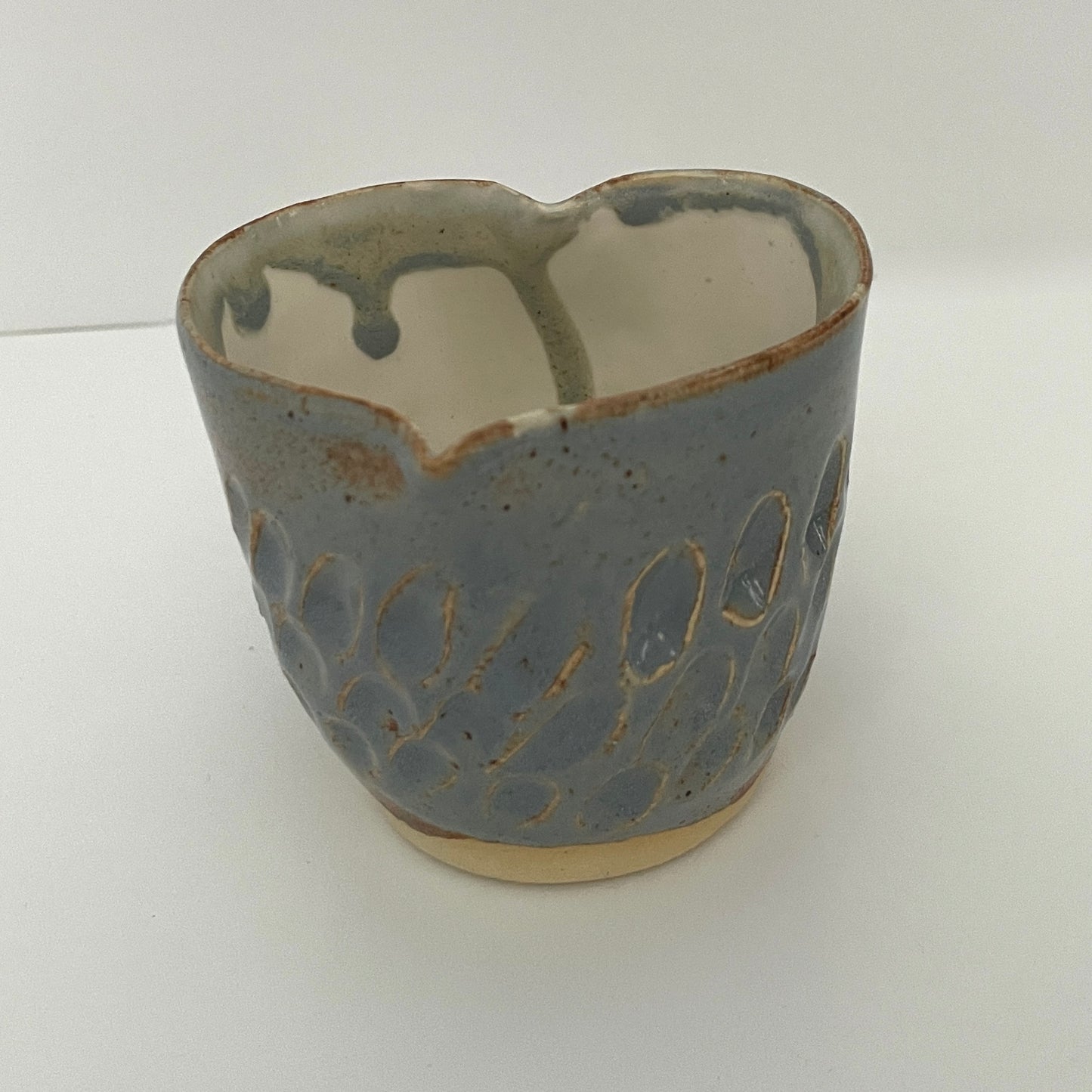 Carved light blue ceramic cups shaped like hearts