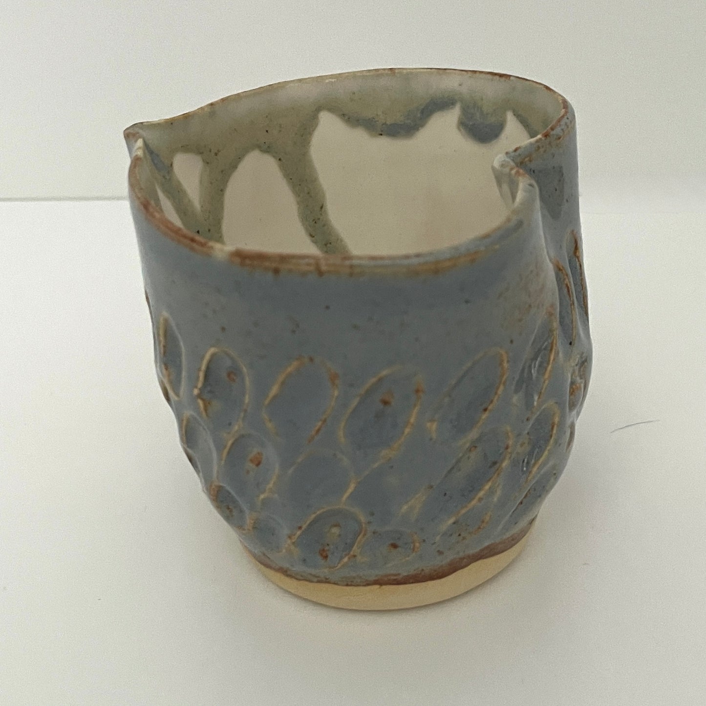 Carved light blue ceramic cups shaped like hearts