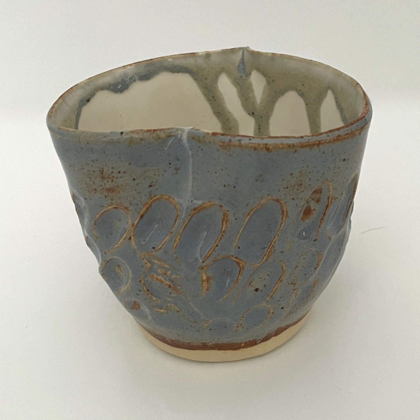 Carved light blue ceramic cups shaped like hearts