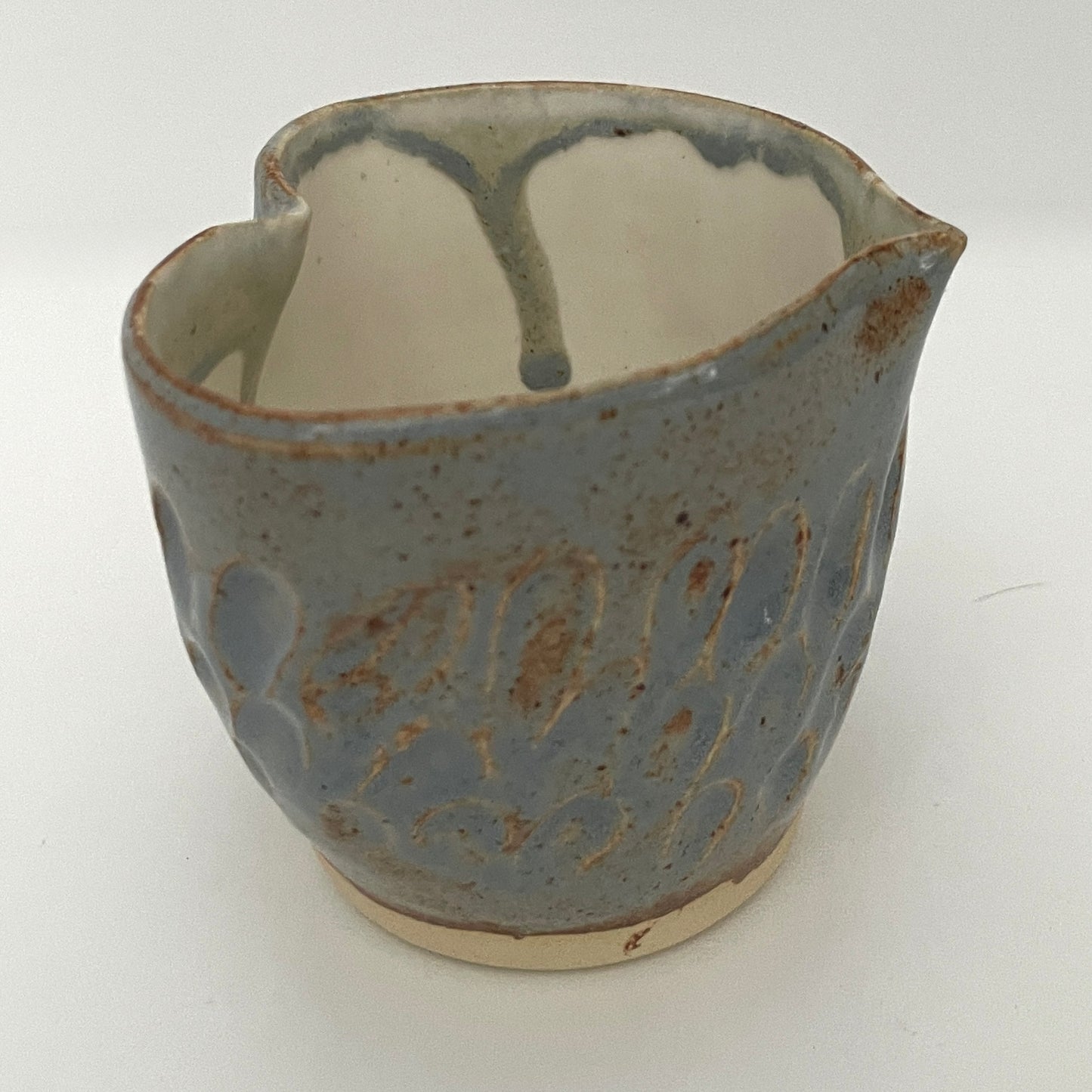 Carved light blue ceramic cups shaped like hearts