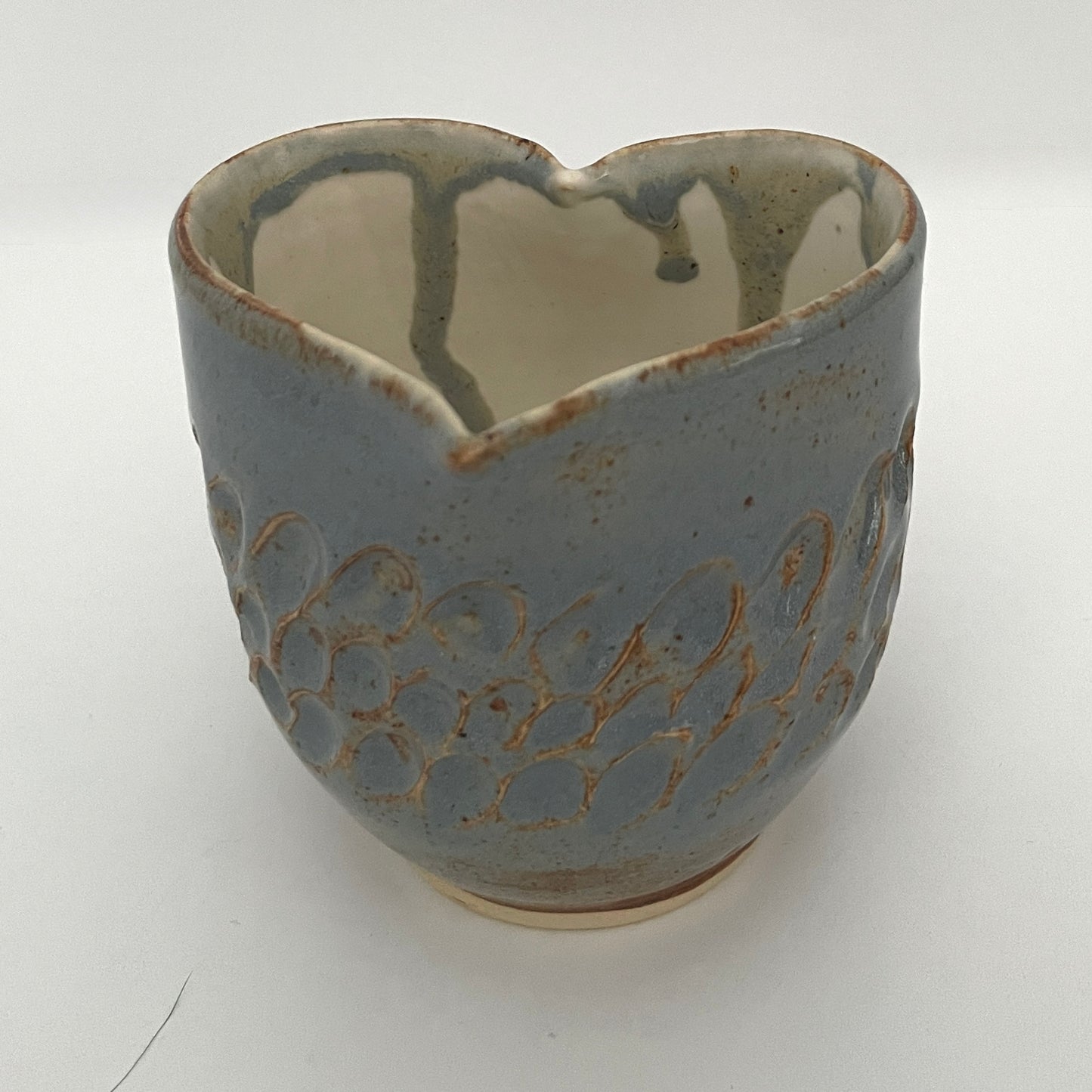 Carved light blue ceramic cups shaped like hearts