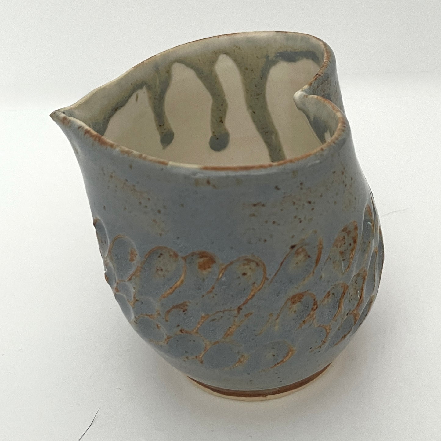 Carved light blue ceramic cups shaped like hearts