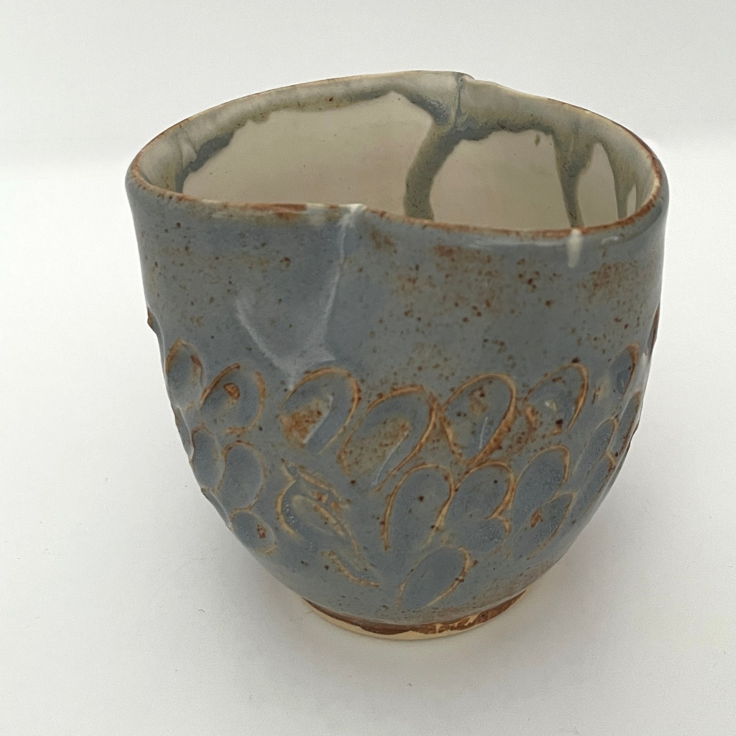 Carved light blue ceramic cups shaped like hearts