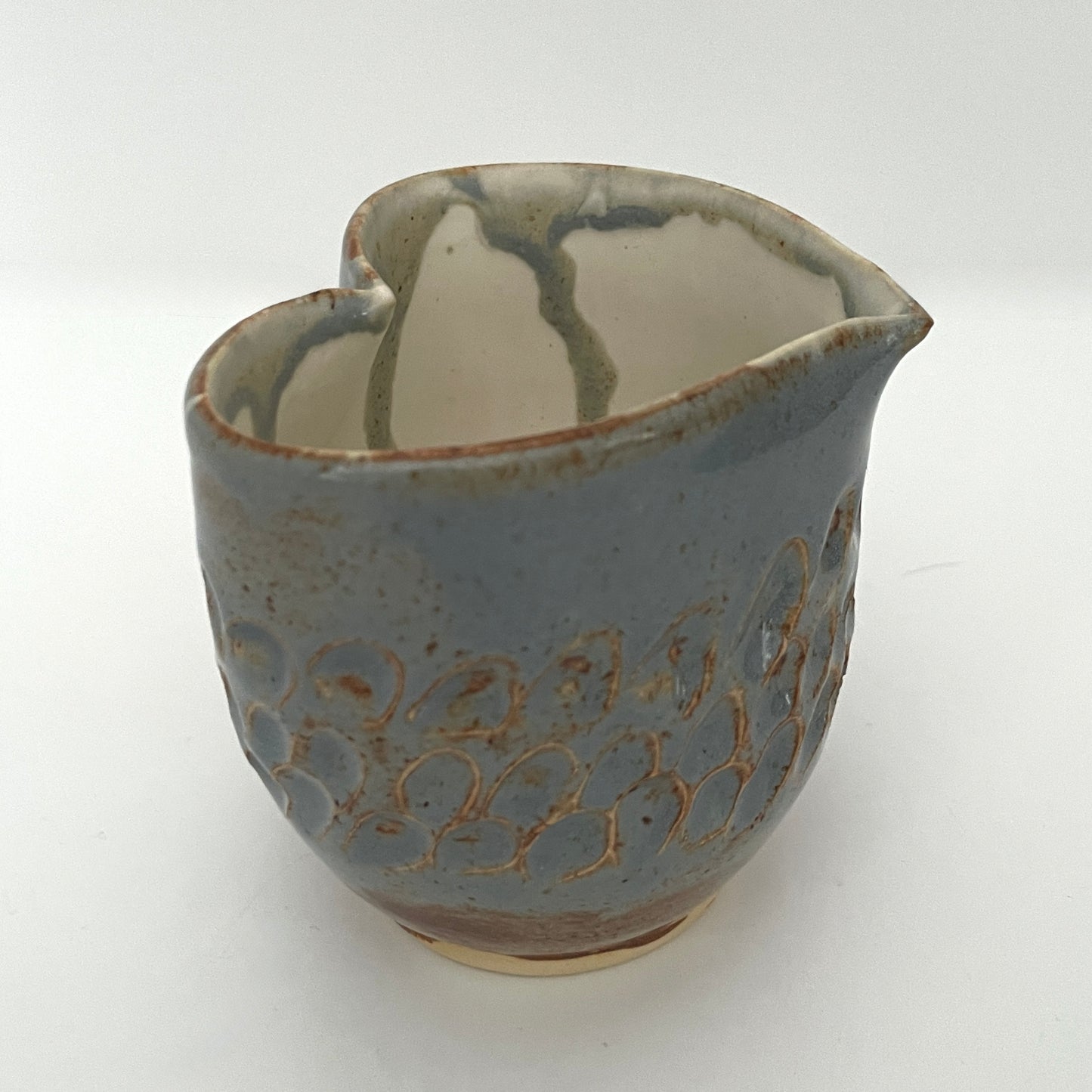 Carved light blue ceramic cups shaped like hearts