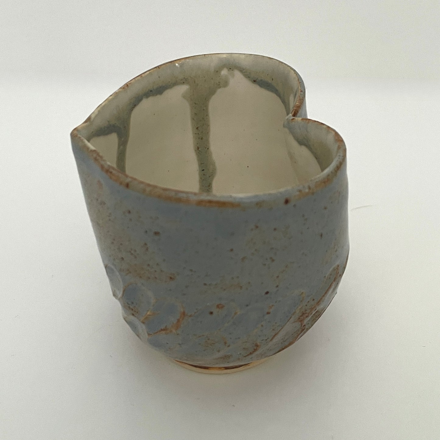 Carved light blue ceramic cups shaped like hearts