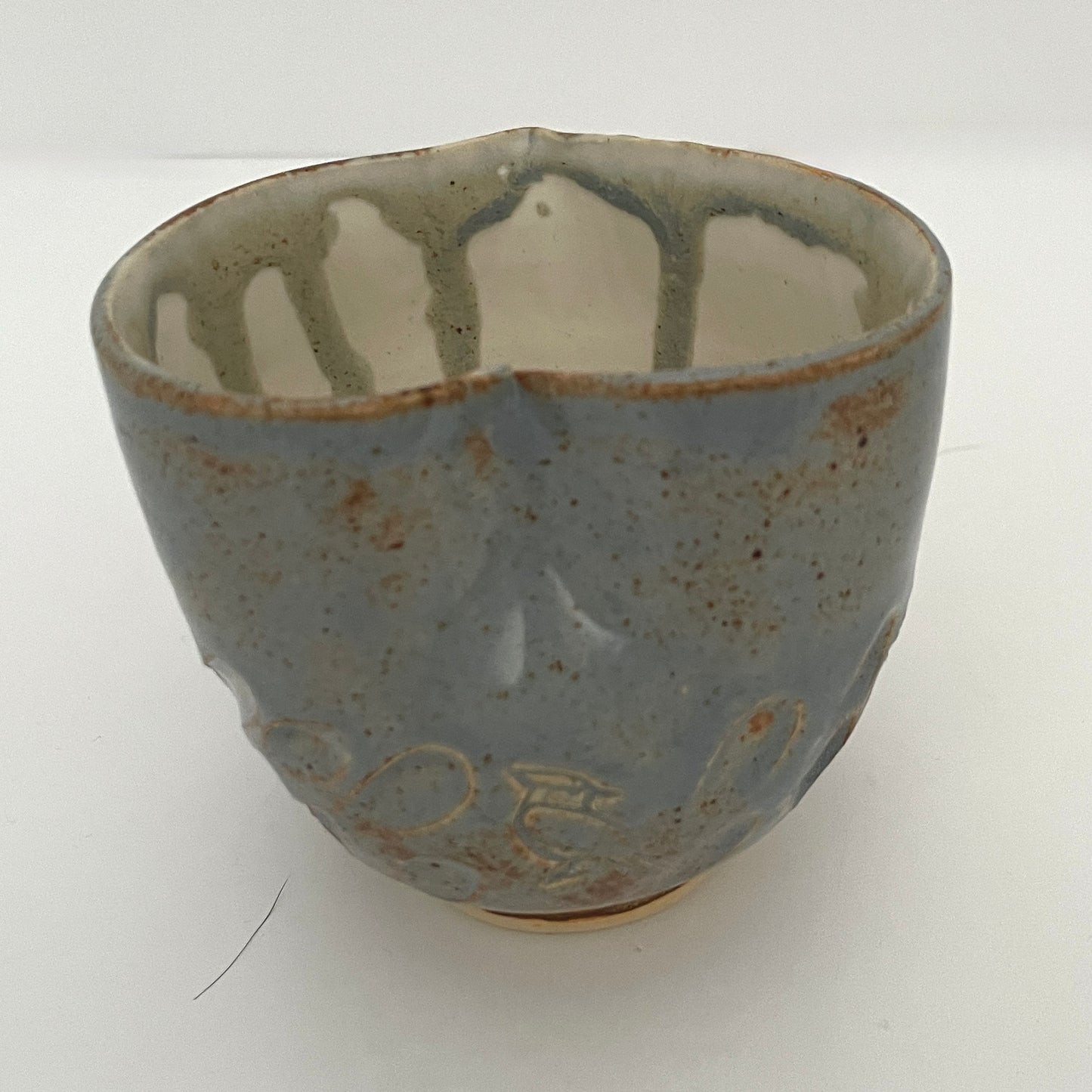 Carved light blue ceramic cups shaped like hearts