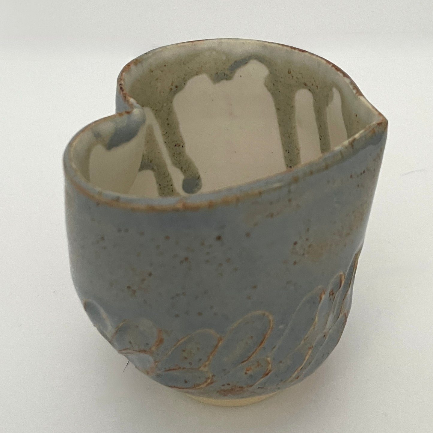 Carved light blue ceramic cups shaped like hearts