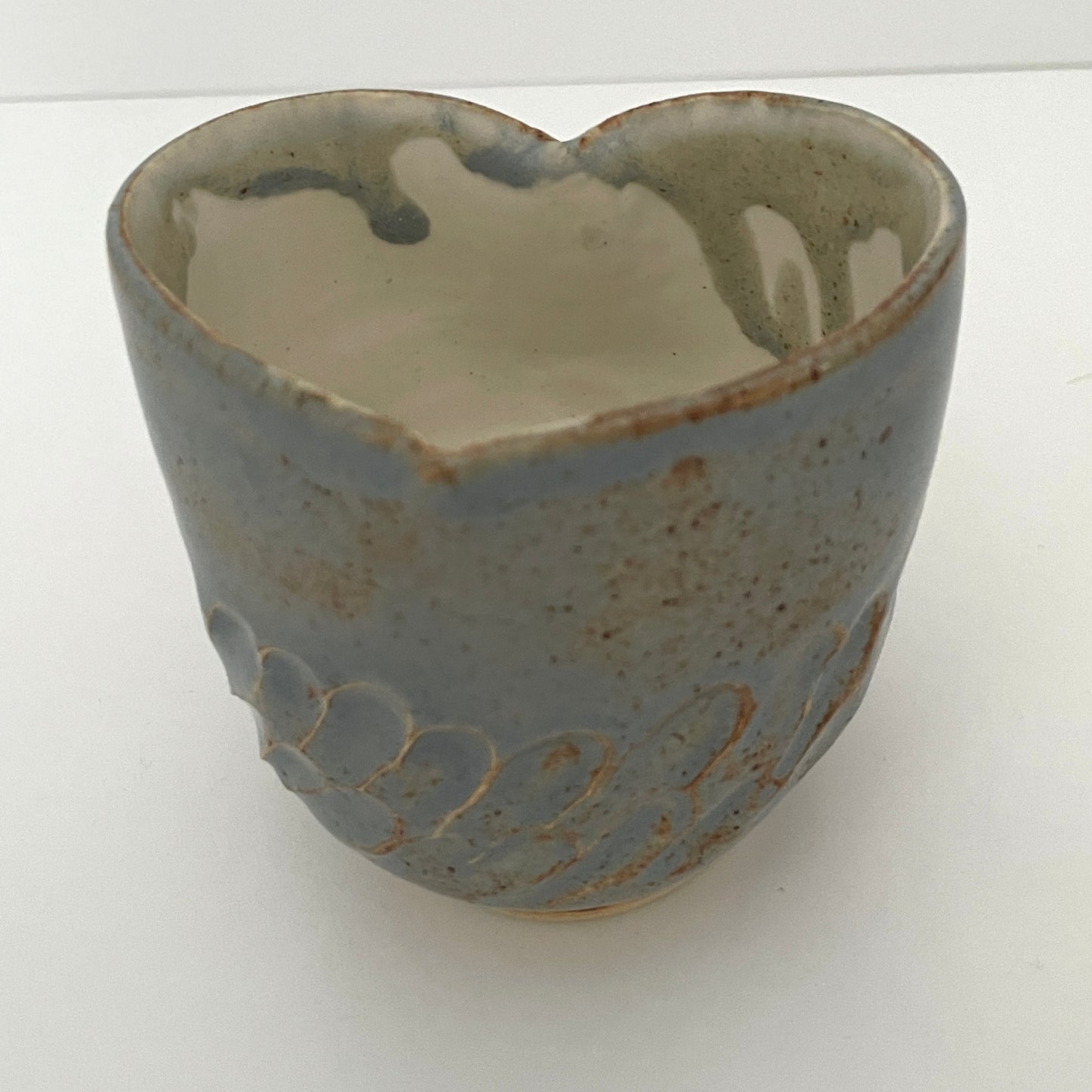 Carved light blue ceramic cups shaped like hearts