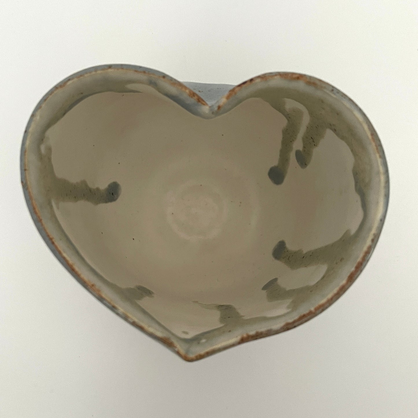 Carved light blue ceramic cups shaped like hearts