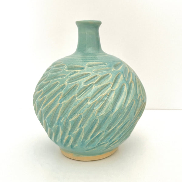 Long neck carved vase in soft blue