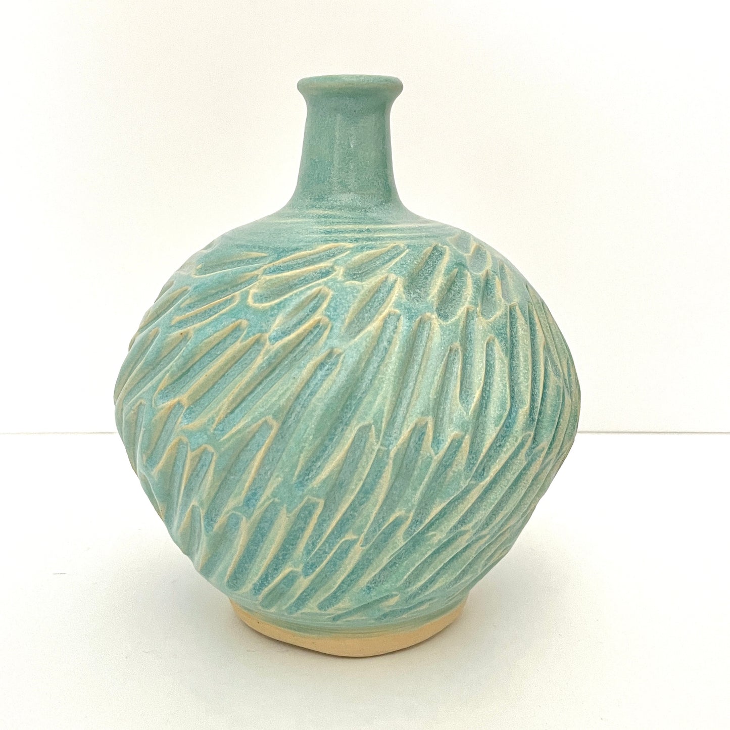Long neck carved vase in soft blue