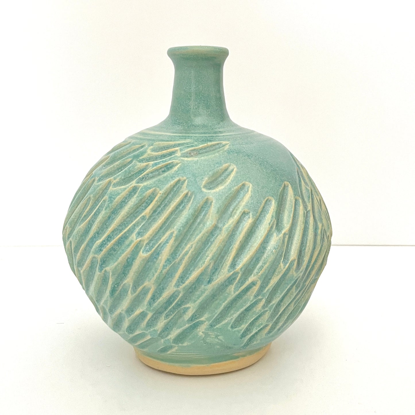 Long neck carved vase in soft blue