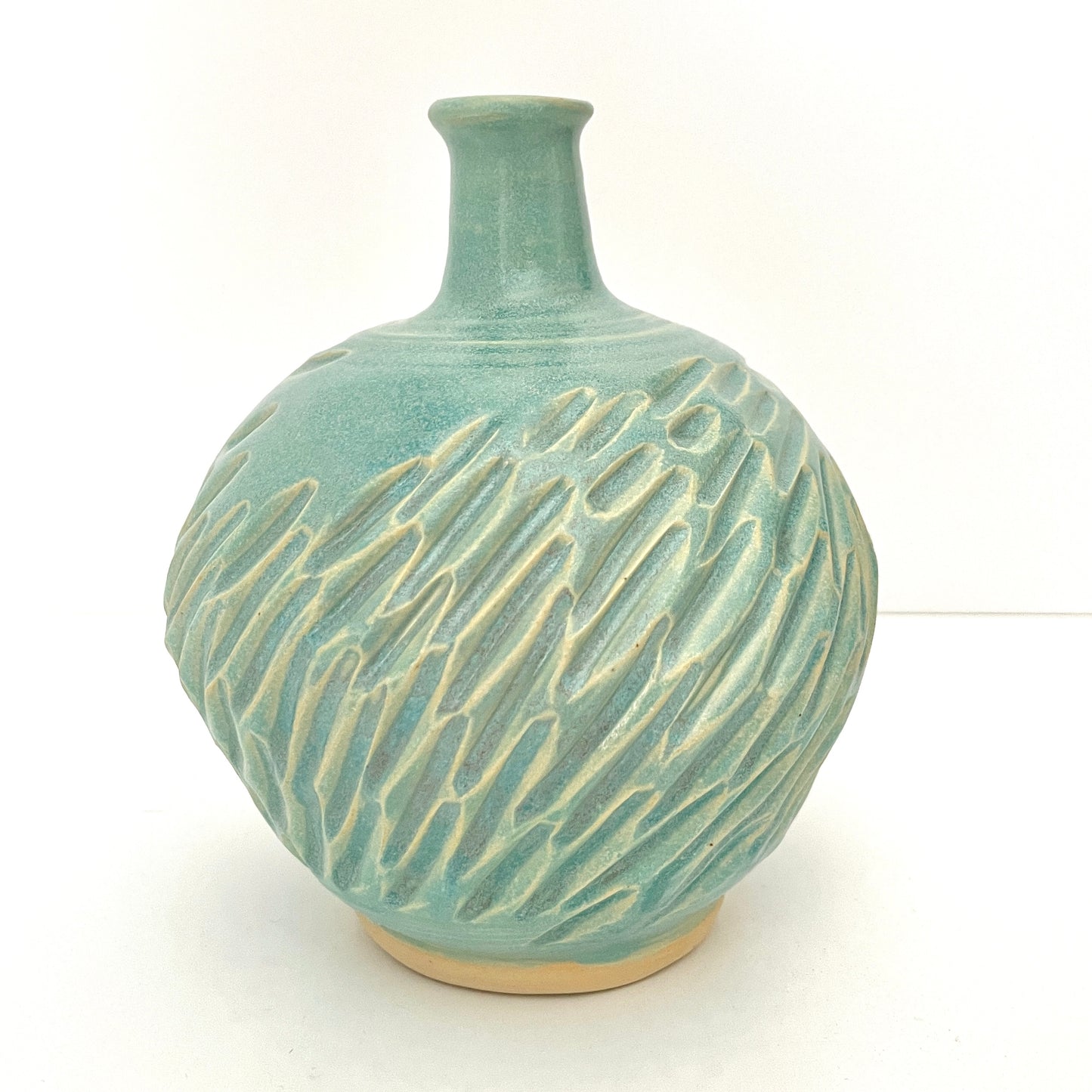Long neck carved vase in soft blue