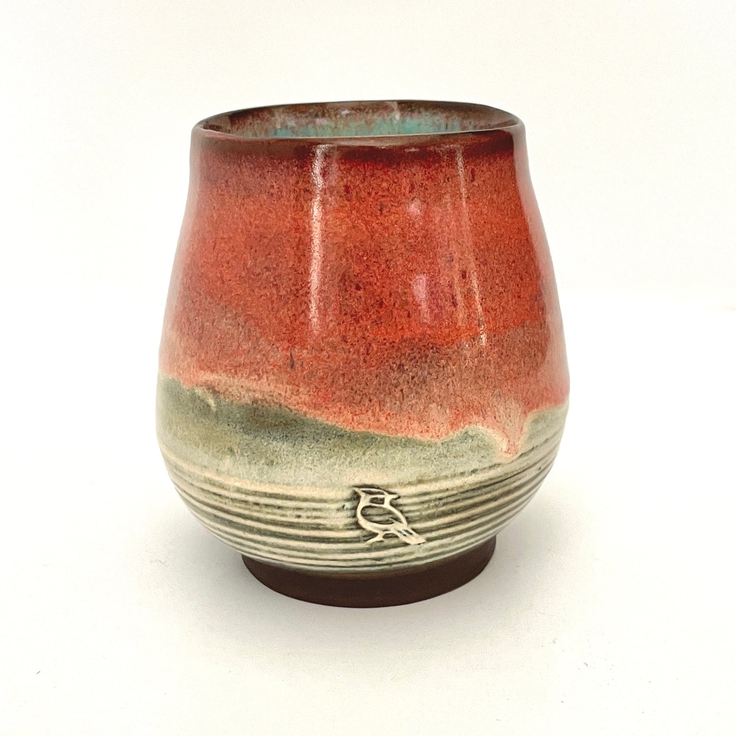 Red and Cream cup with Turquoise interior on Dark Clay