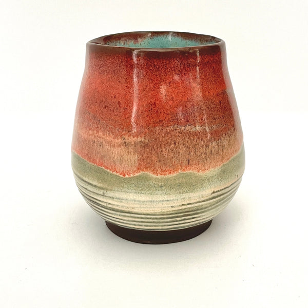 Red and Cream cup with Turquoise interior on Dark Clay