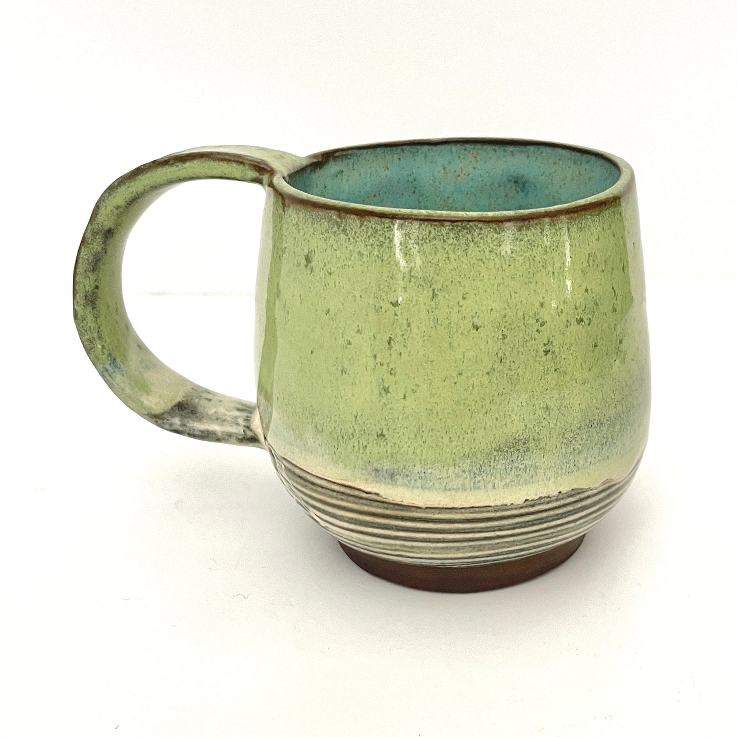 Green with Turquoise Interior Mug on Dark Clay
