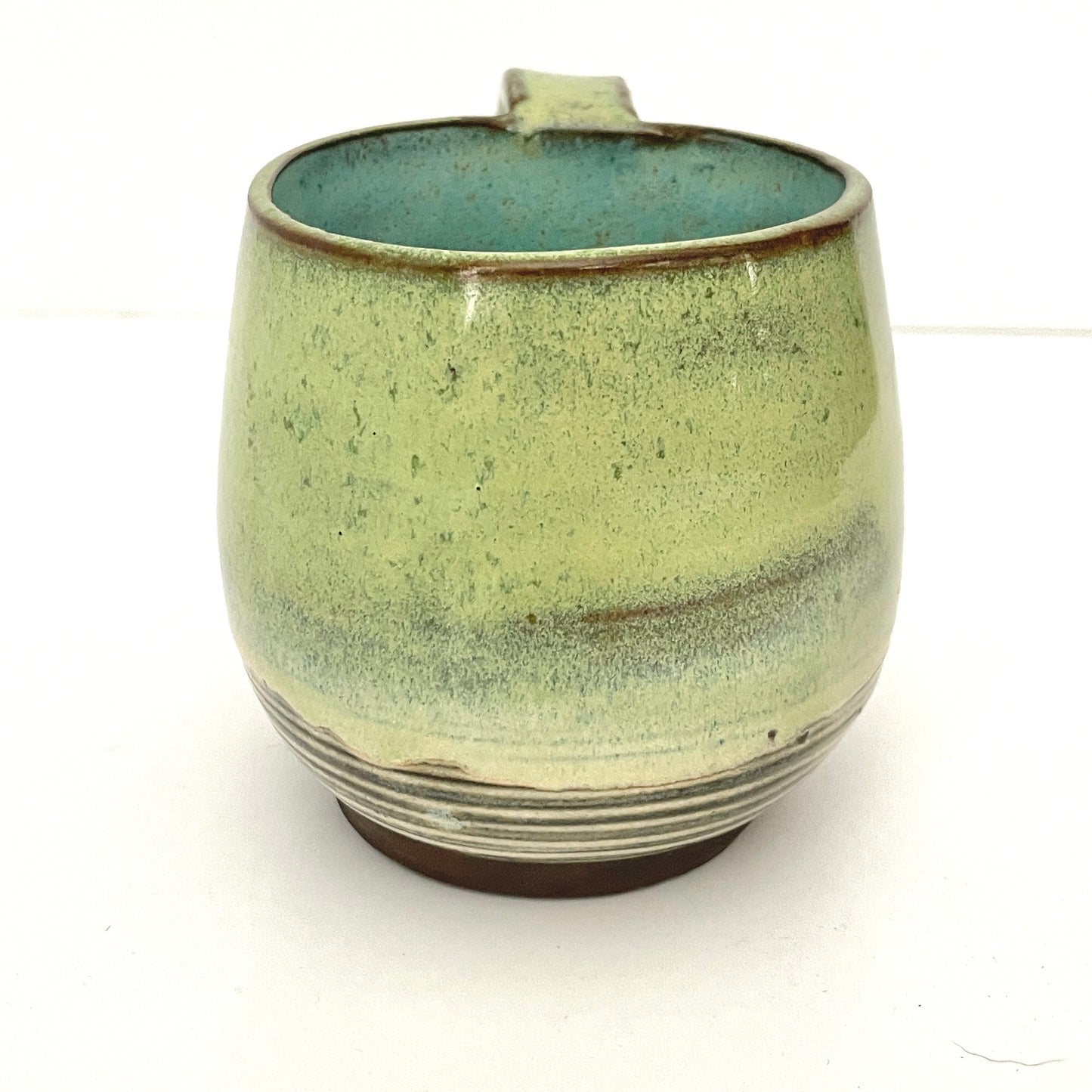 Green with Turquoise Interior Mug on Dark Clay