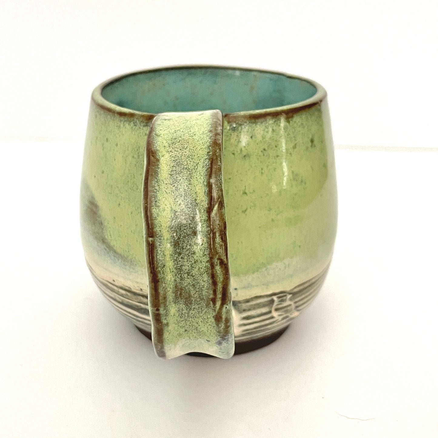 Green with Turquoise Interior Mug on Dark Clay