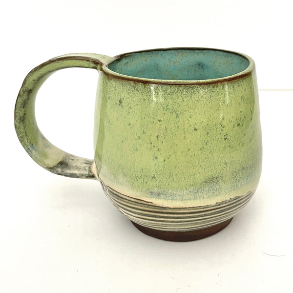 Green with Turquoise Interior Mug on Dark Clay