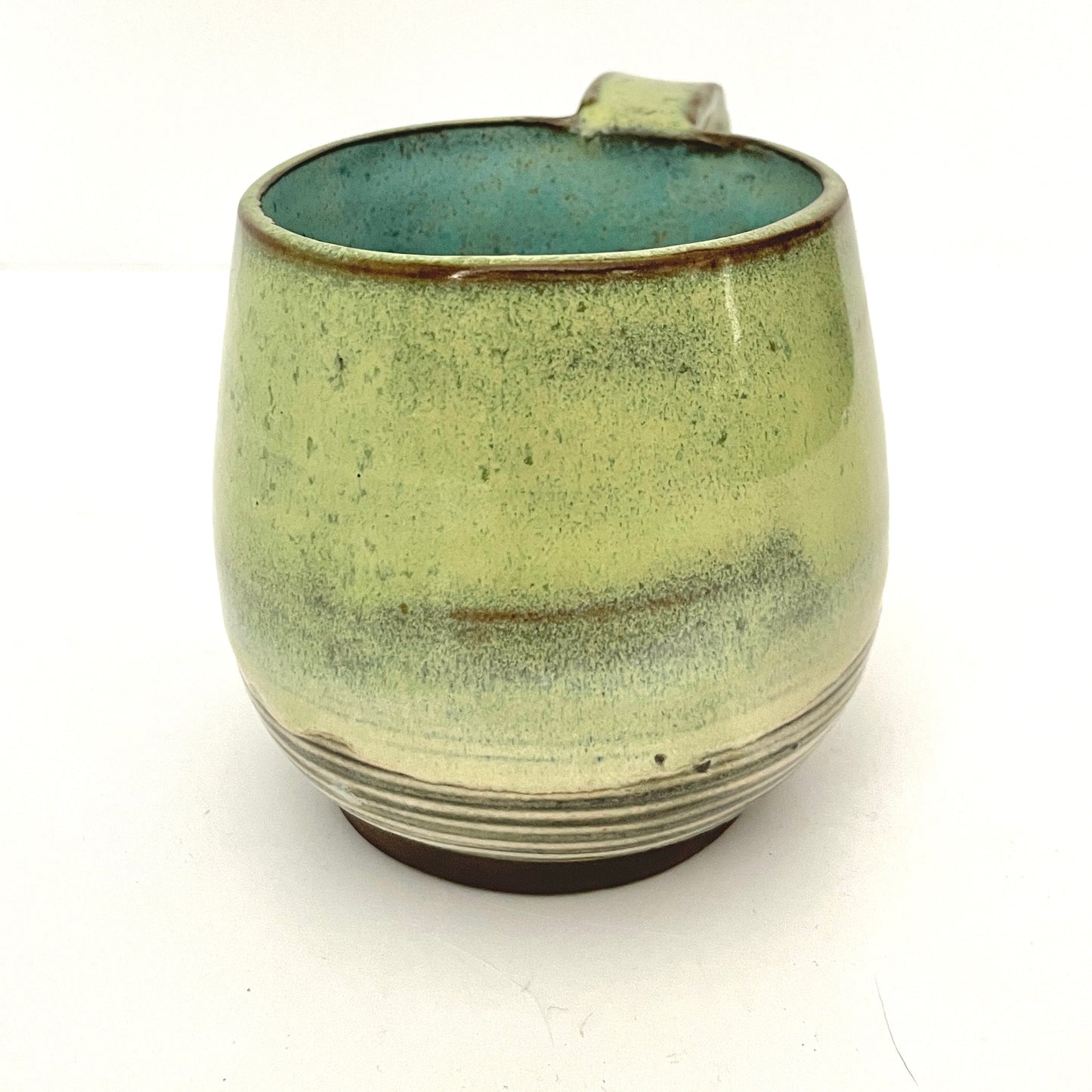 Green with Turquoise Interior Mug on Dark Clay