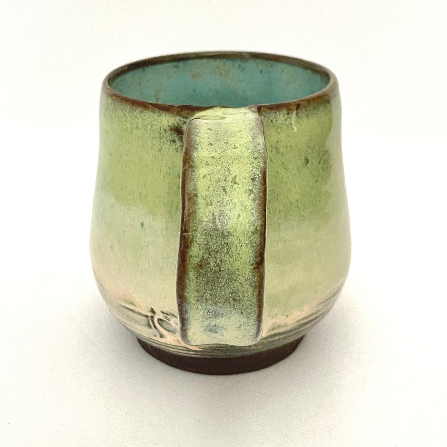 Green with Turquoise Interior Mug on Dark Clay