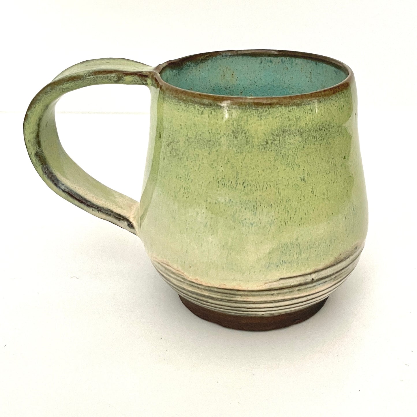 Green with Turquoise Interior Mug on Dark Clay
