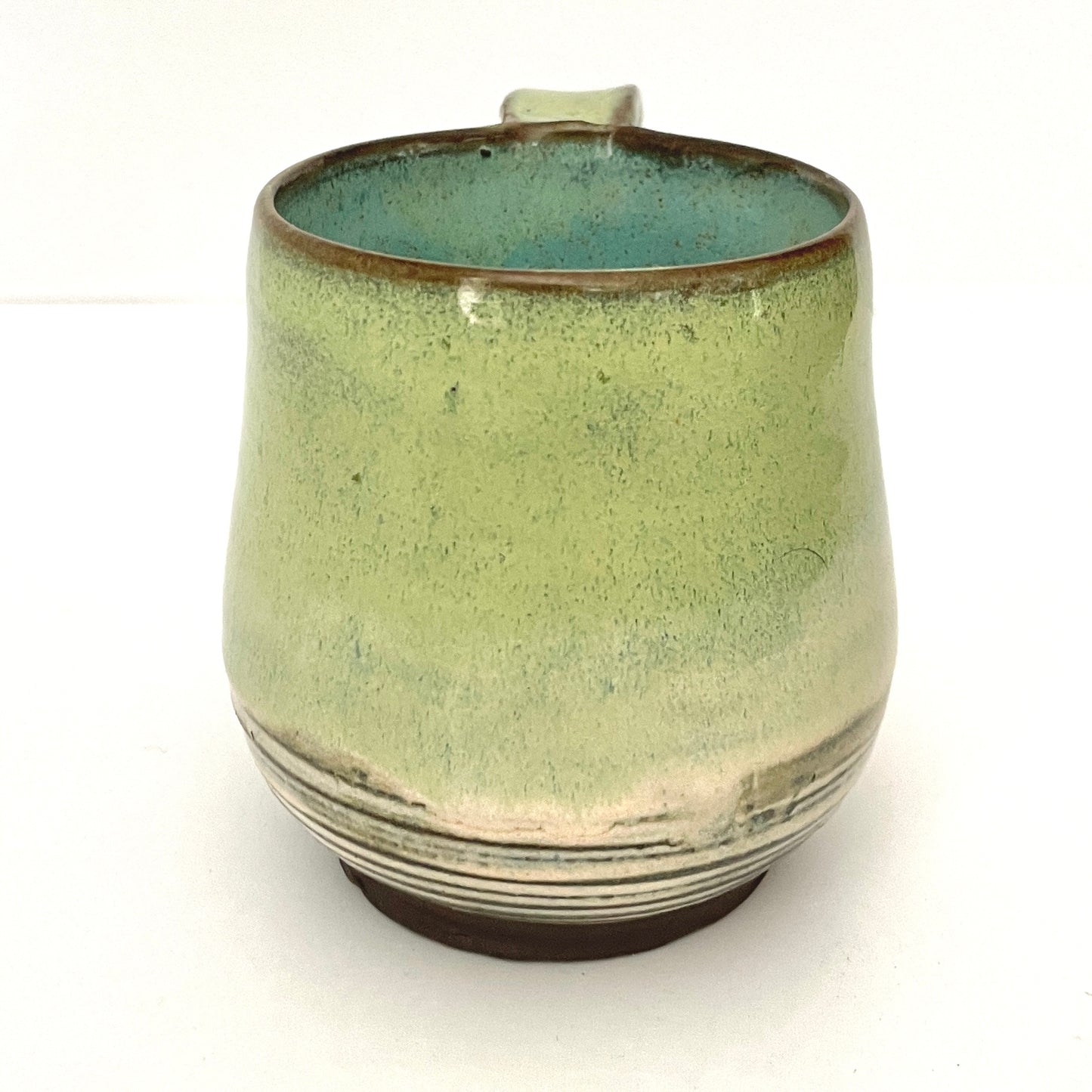 Green with Turquoise Interior Mug on Dark Clay
