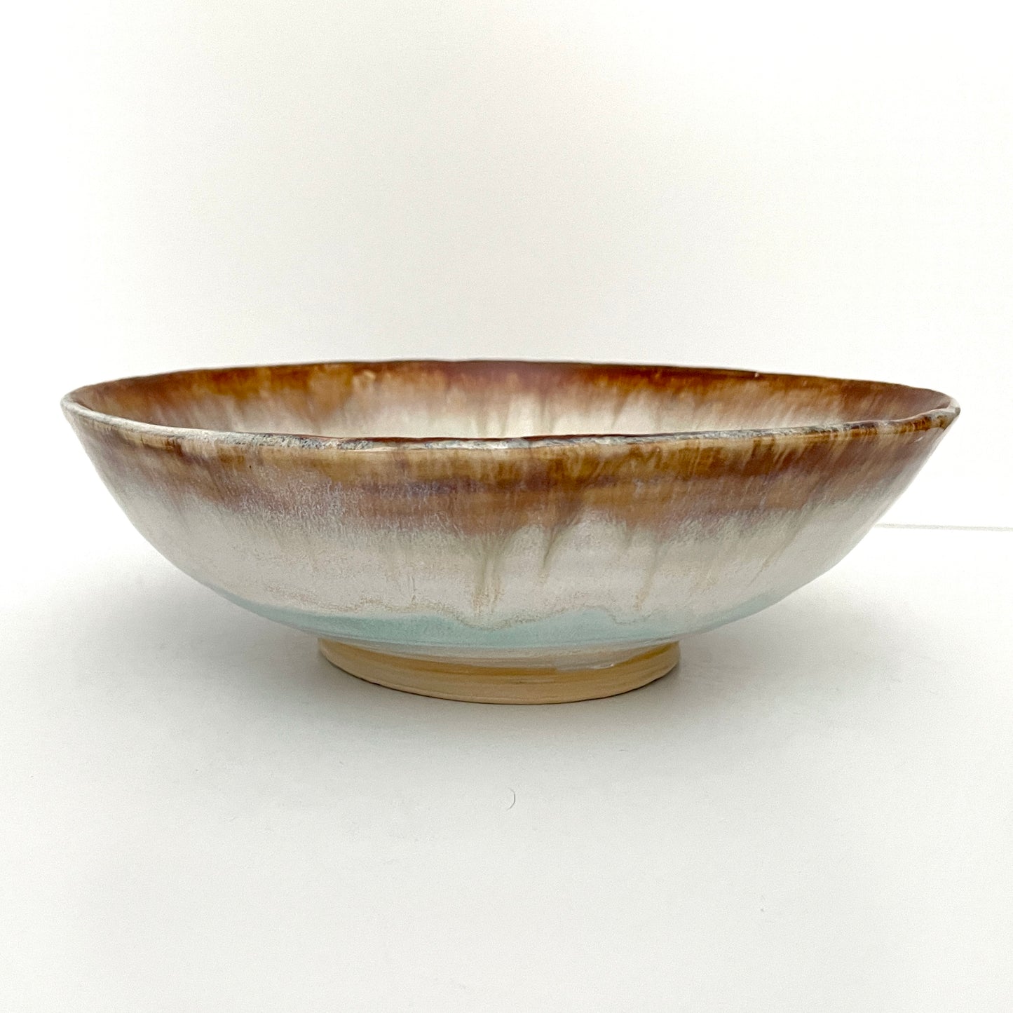 Dramatic serving or decorative bowl in white, seafoam green and rust,