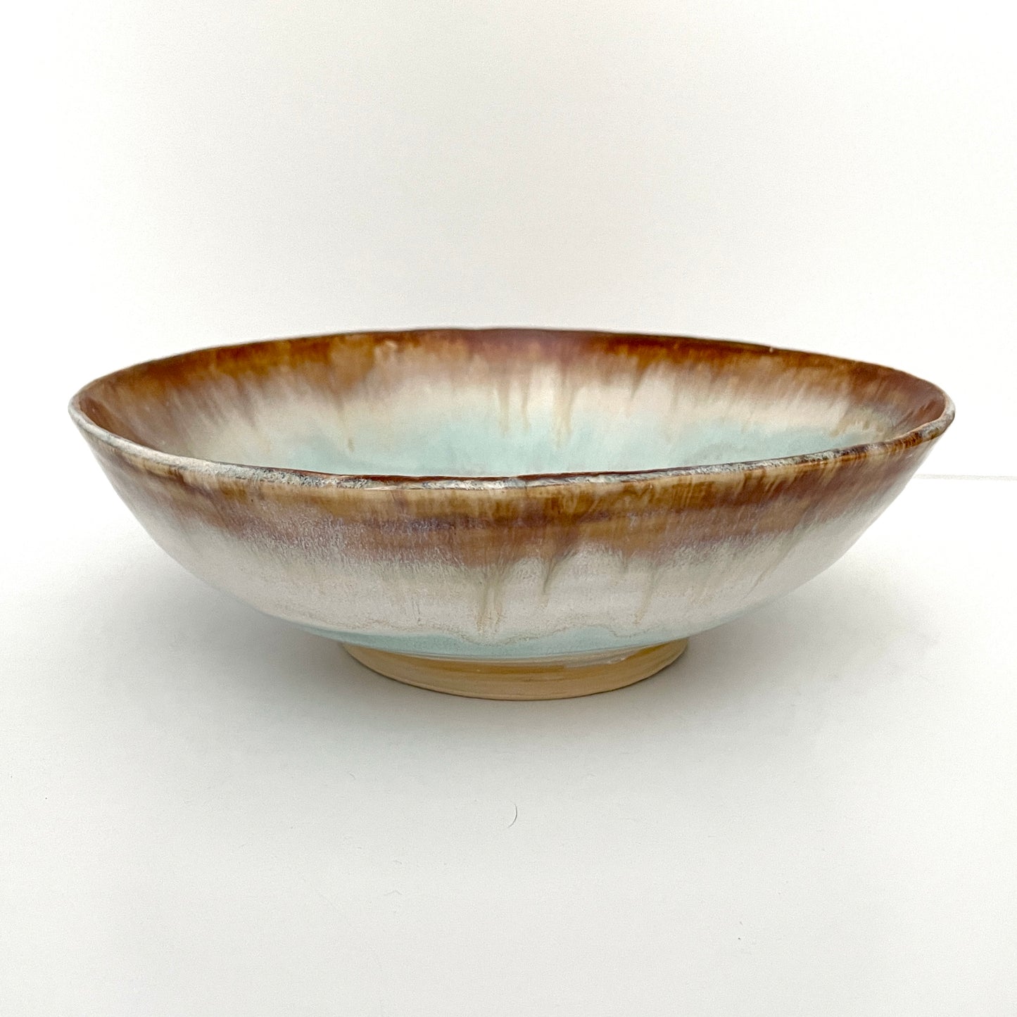 Dramatic serving or decorative bowl in white, seafoam green and rust,