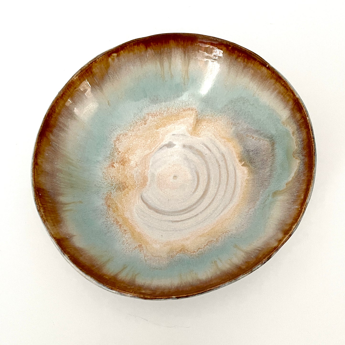 Dramatic serving or decorative bowl in white, seafoam green and rust,