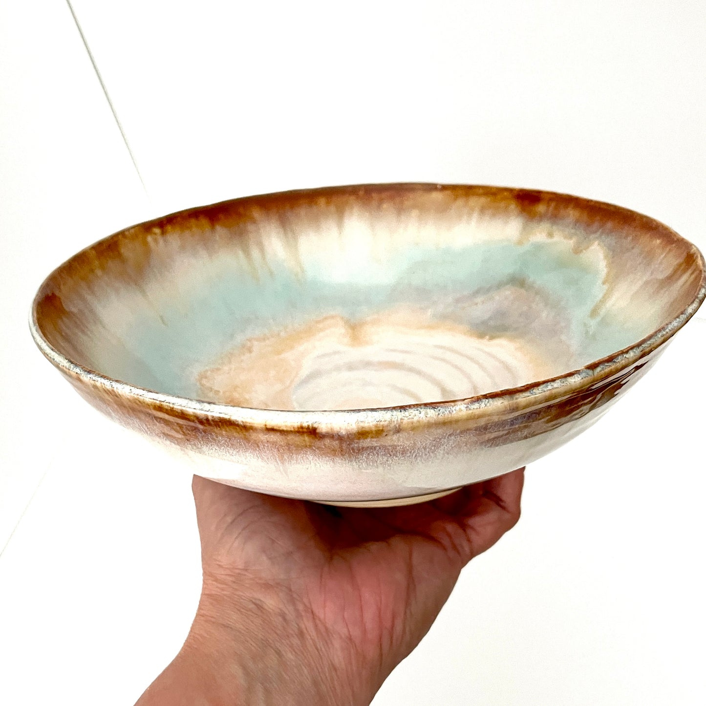 Dramatic serving or decorative bowl in white, seafoam green and rust,