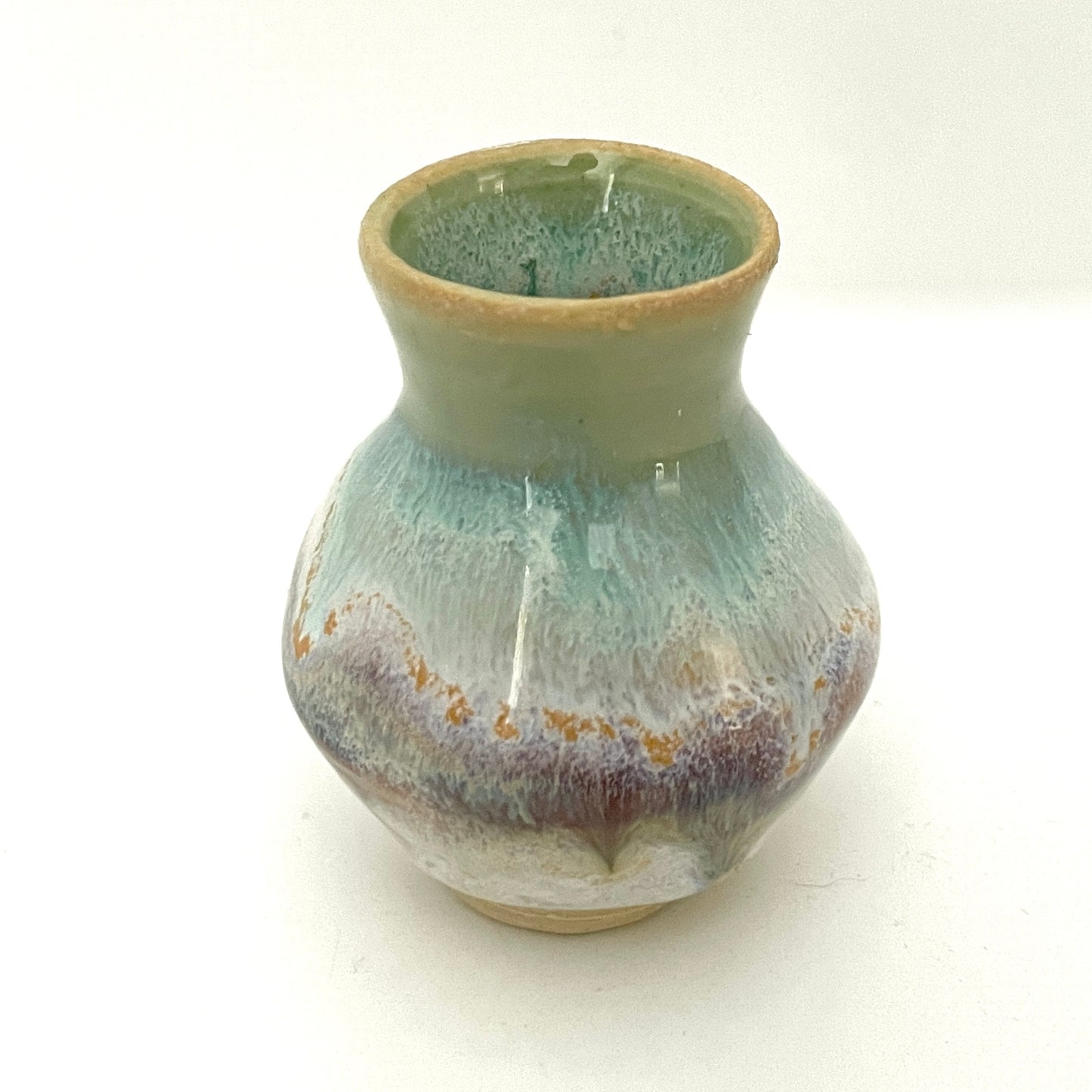 Decorative mini vases in white, seafoam green and rust.