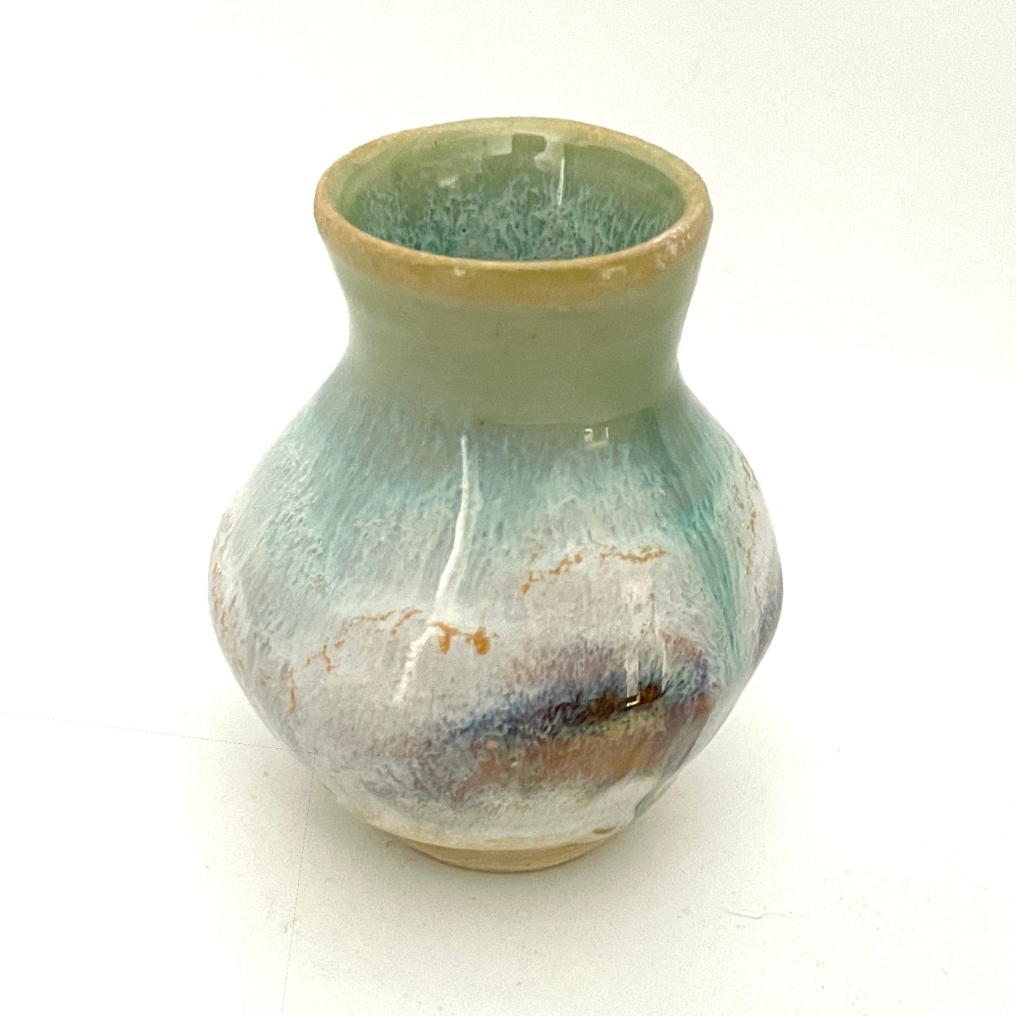 Decorative mini vases in white, seafoam green and rust.
