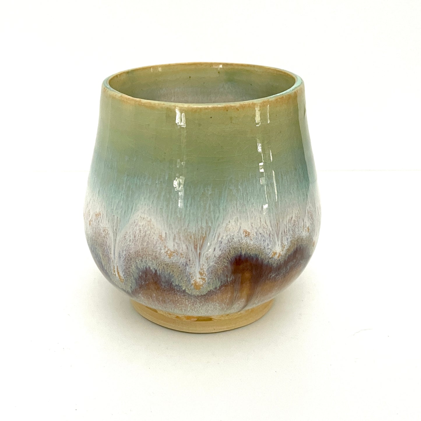 Small Delicate tea or drink cups in tones of white, seafoam and rust.