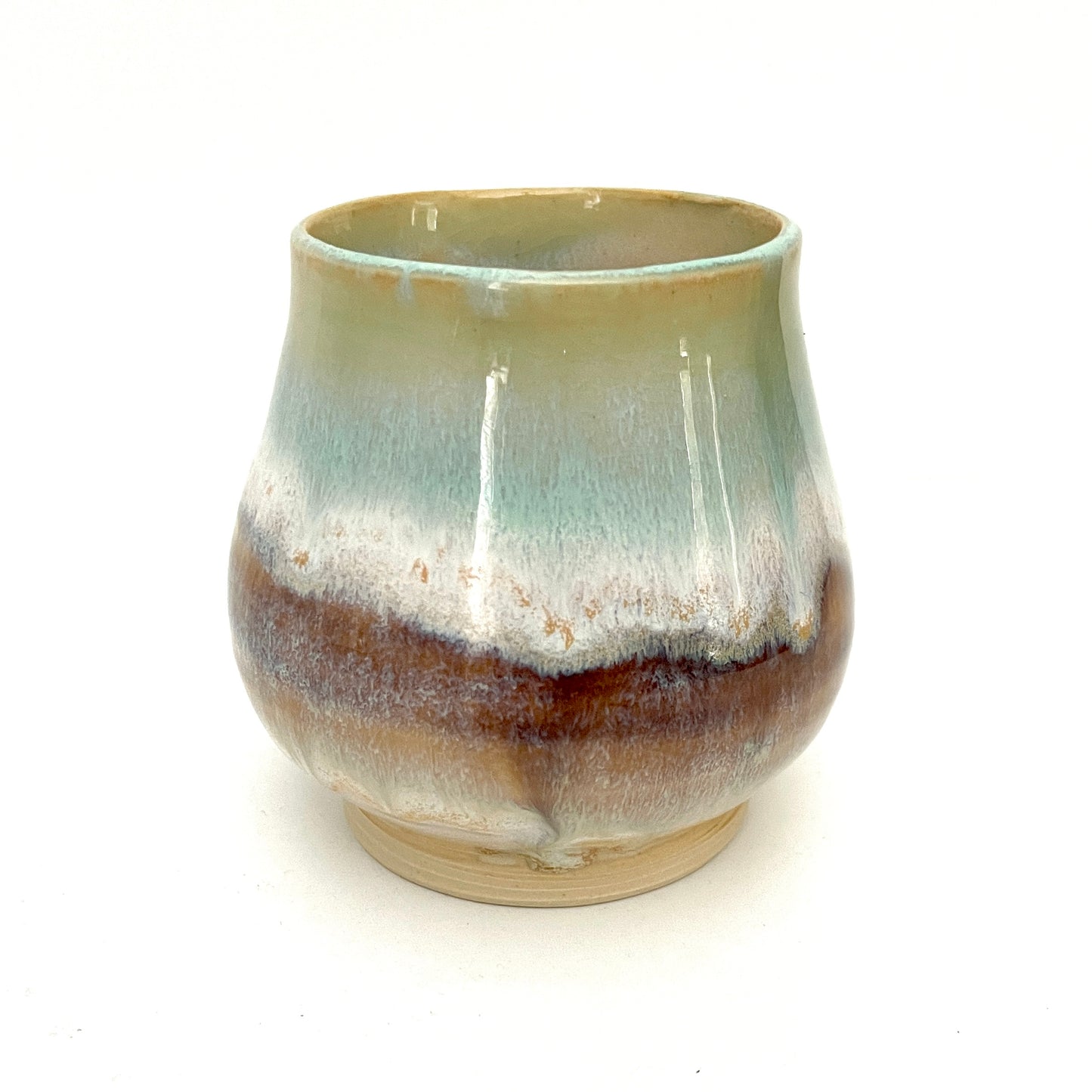 Small Delicate tea or drink cups in tones of white, seafoam and rust.