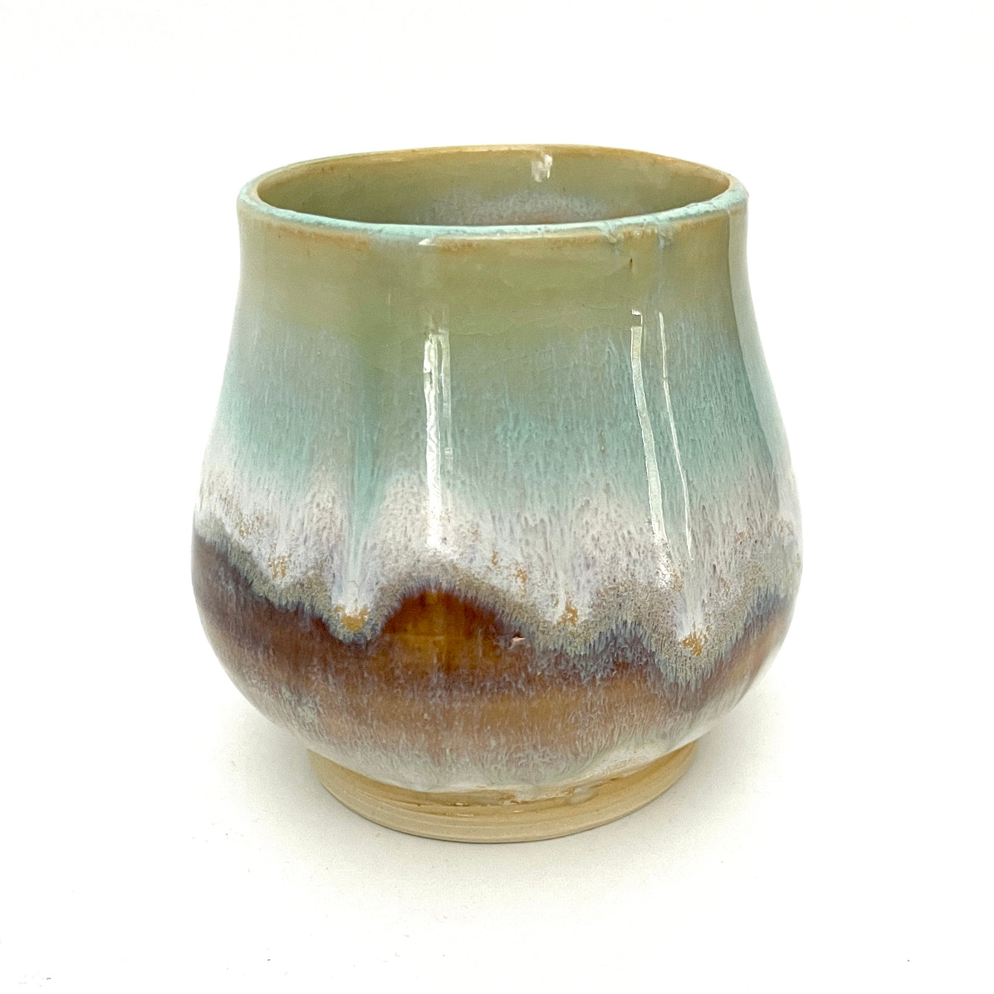Small Delicate tea or drink cups in tones of white, seafoam and rust.