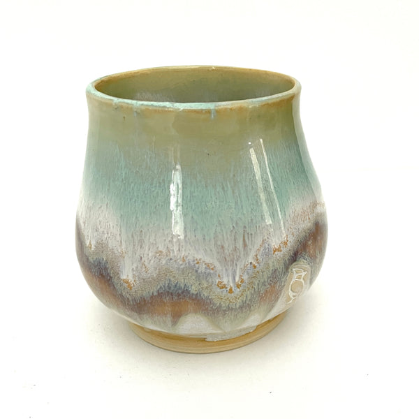 Small Delicate tea or drink cups in tones of white, seafoam and rust.