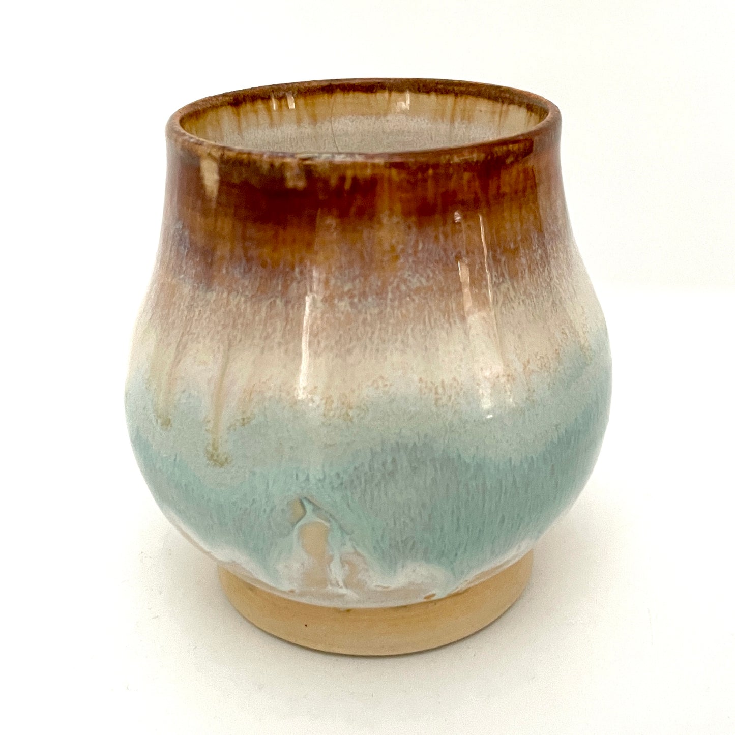 Small Delicate tea or drink cups in tones of white, seafoam and rust.