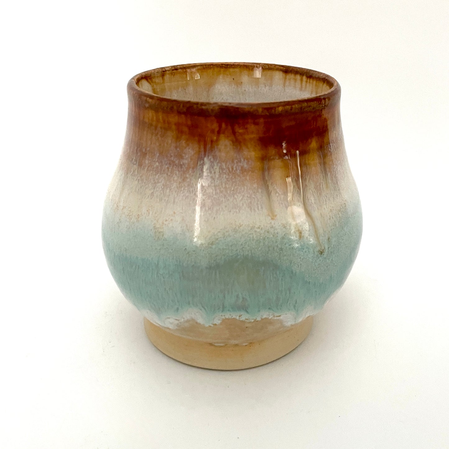 Small Delicate tea or drink cups in tones of white, seafoam and rust.