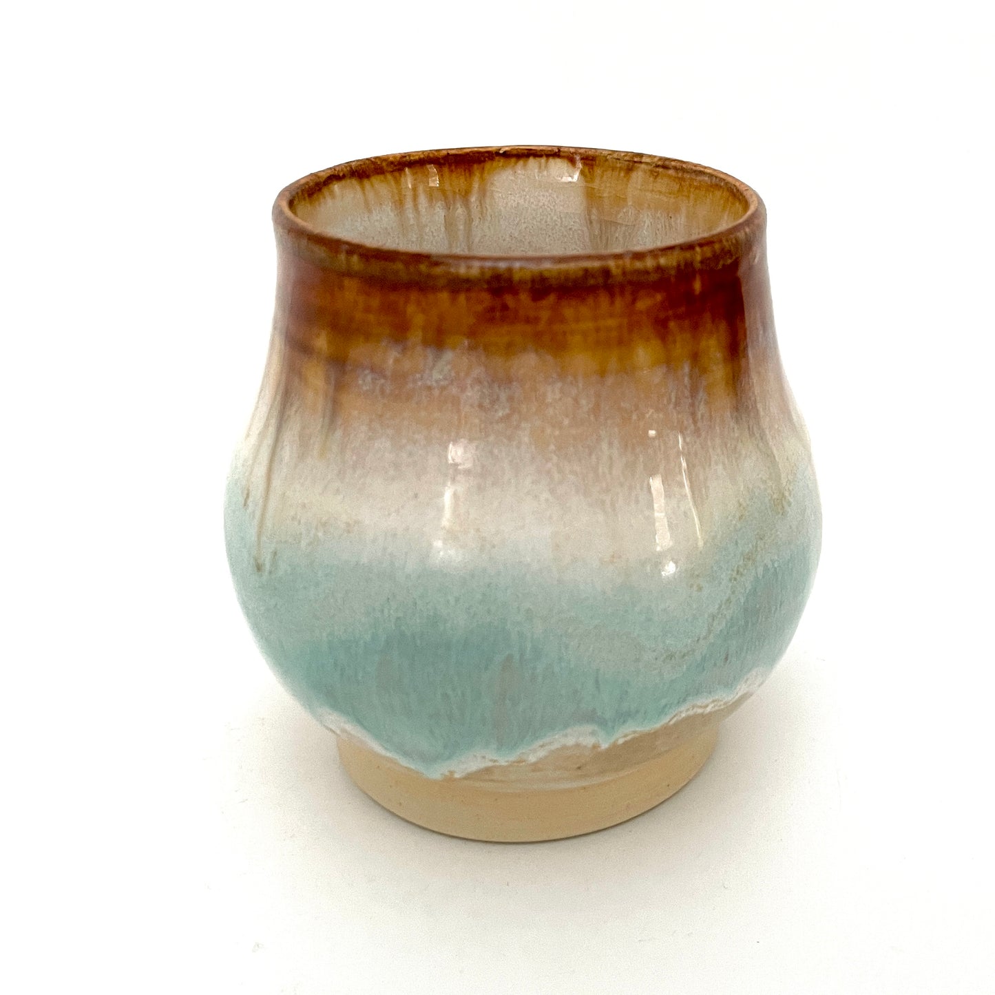 Small Delicate tea or drink cups in tones of white, seafoam and rust.