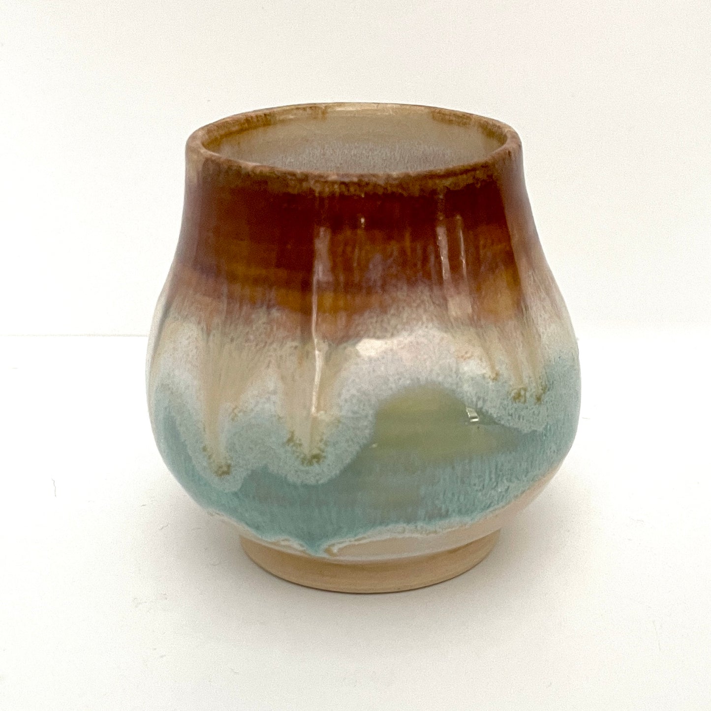 Small Delicate tea or drink cups in tones of white, seafoam and rust.