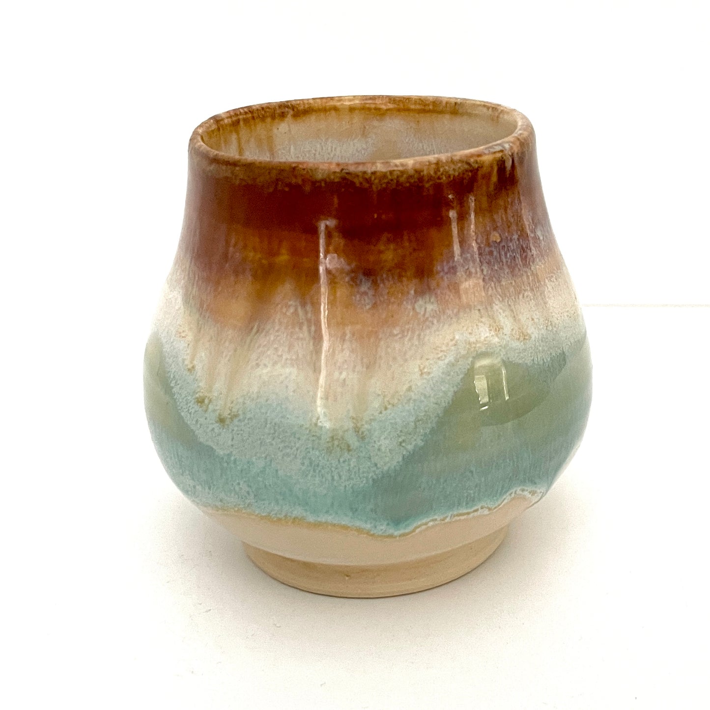 Small Delicate tea or drink cups in tones of white, seafoam and rust.