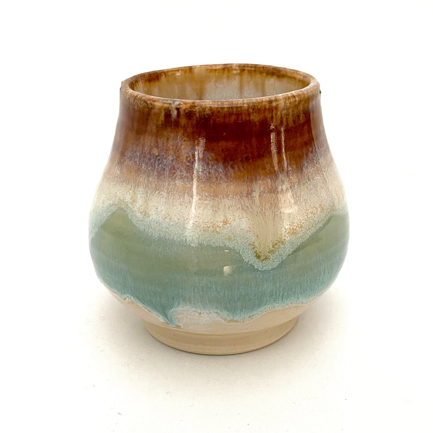 Small Delicate tea or drink cups in tones of white, seafoam and rust.