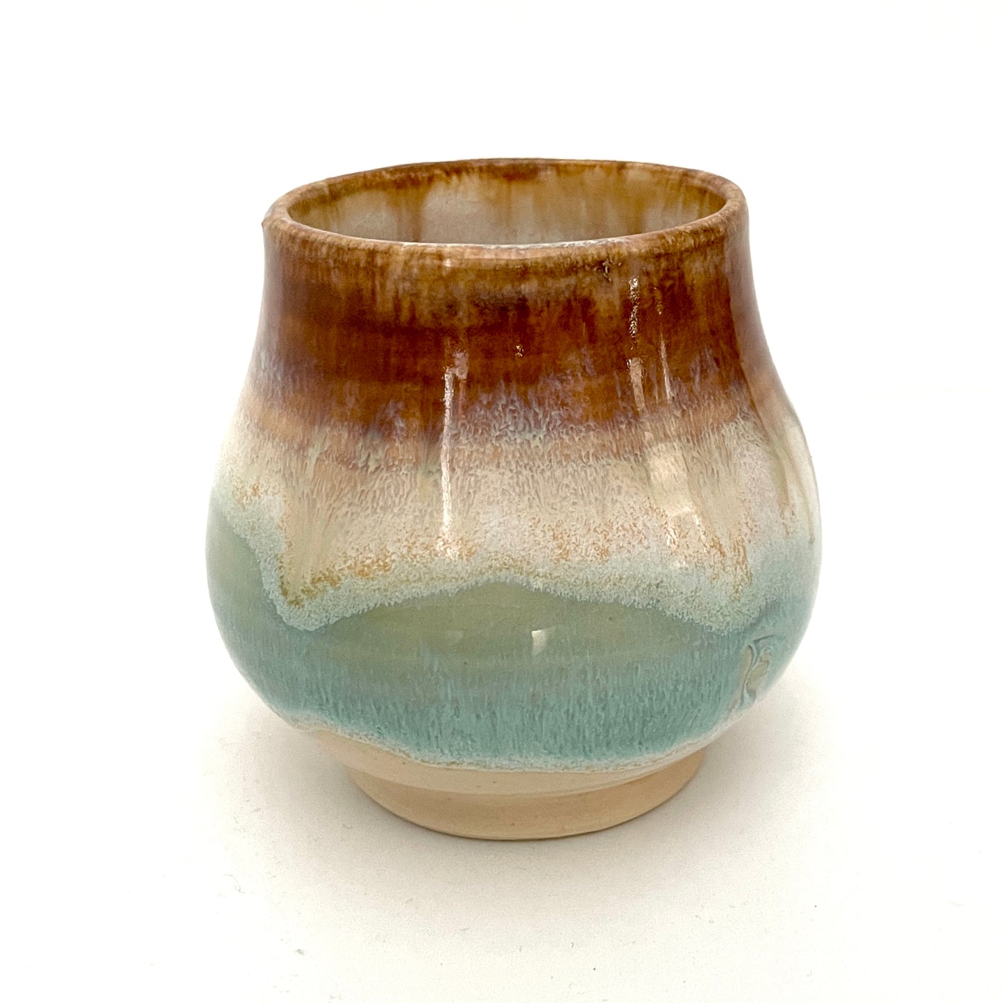 Small Delicate tea or drink cups in tones of white, seafoam and rust.